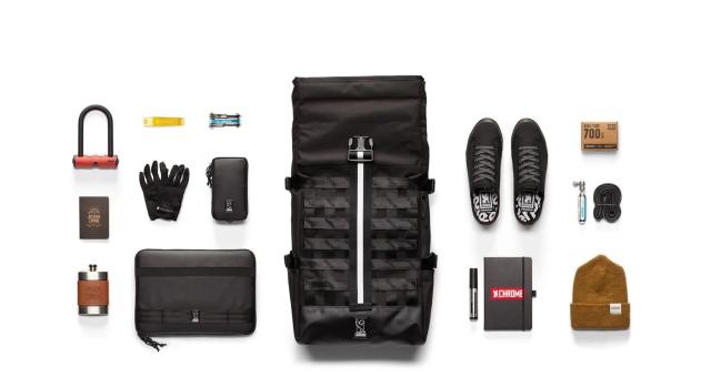 The black Barrage Cargo backpack with contents including lock, gloves, notebook, shoes, hat, laptop and bike repair tools