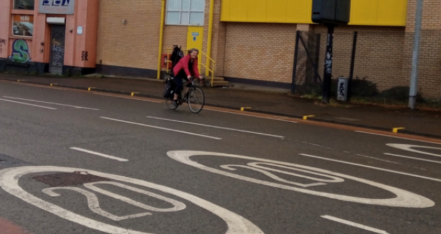 Cycling UK staff member Gwenda Owen cycling on a 20mph road in Cardiff