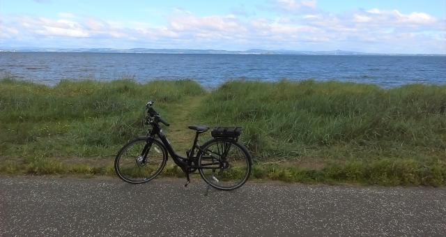 E-bike on promenade with sea behind