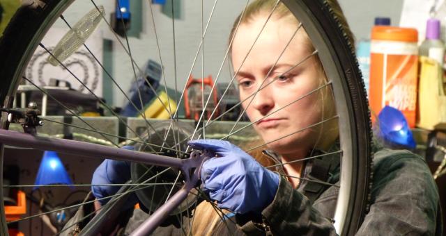 Sylvia Barnett works on a bike at the Plattfields Bike Hub