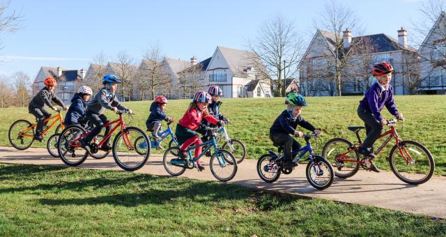 Children cycling in park