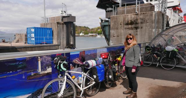 A touring cyclist waits for a ferry with their bike