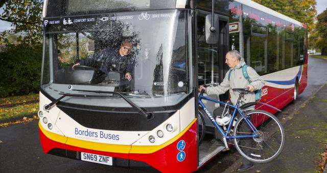 man boarding bus with bike
