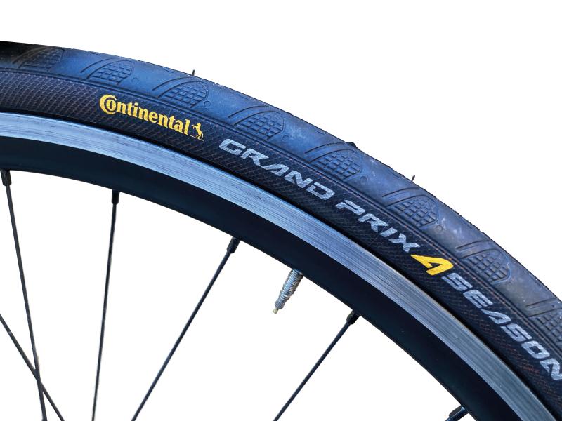 A close-up of the Continental Grand Prix 4-Season tyre showing the logo on a bicycle wheel