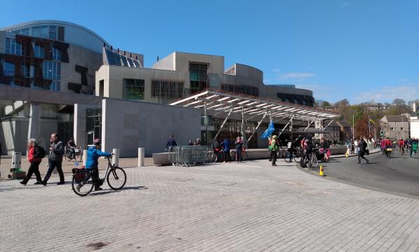 Scottish Parliament Building Holyrood with people walking and cycling outside