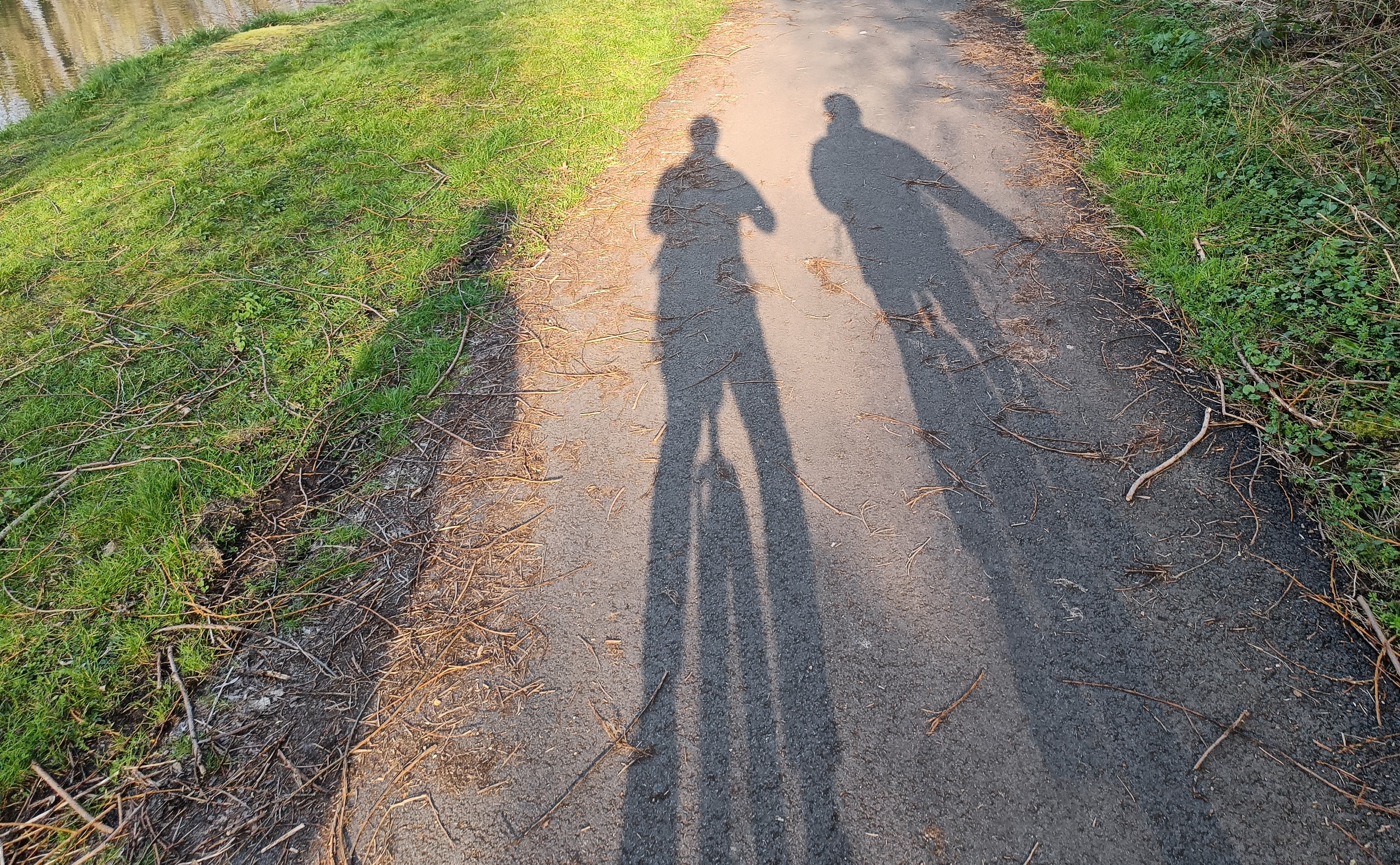 Shadows of three people riding unicycles