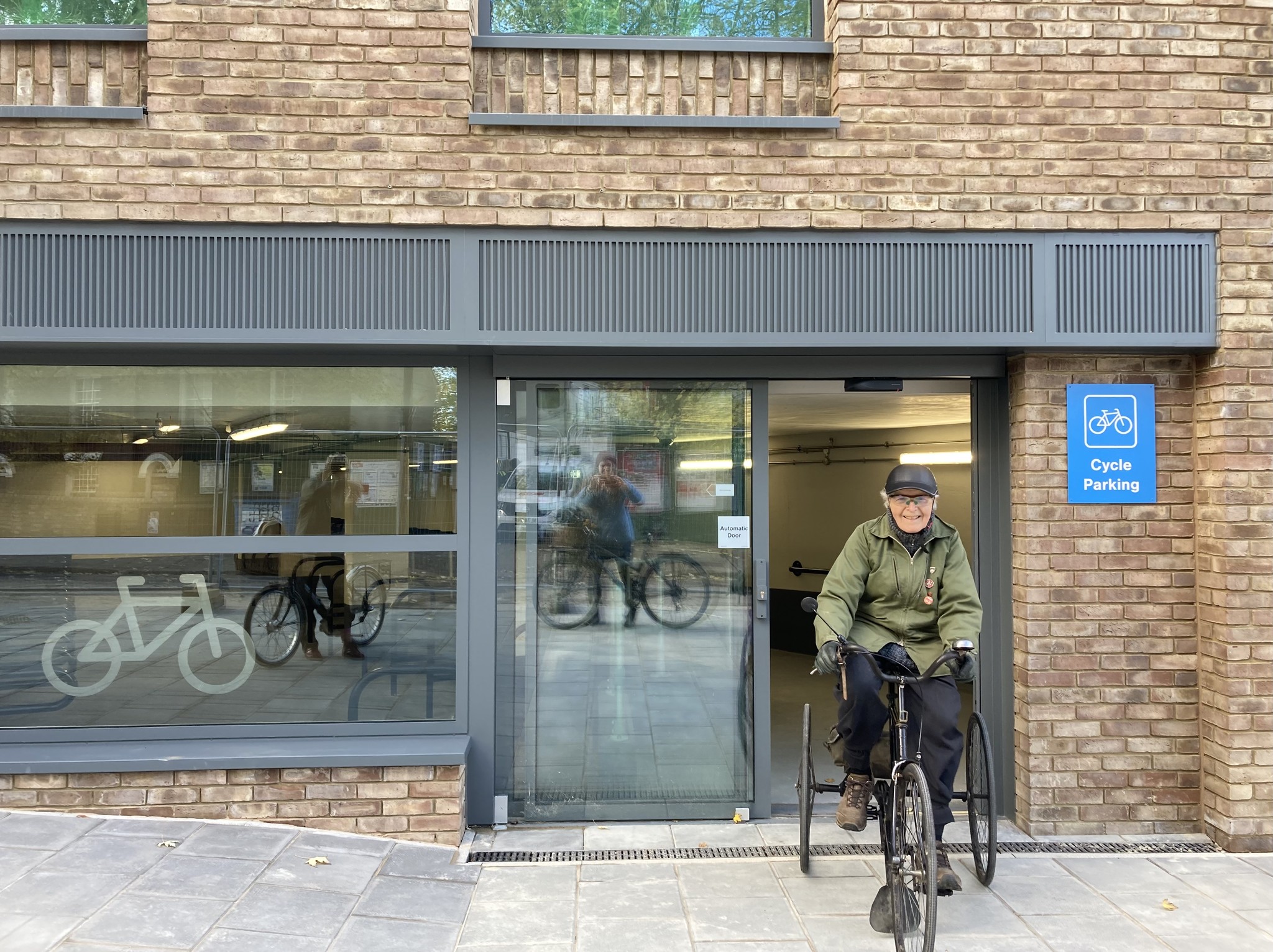 A man is riding a tricycle out of a cycle park