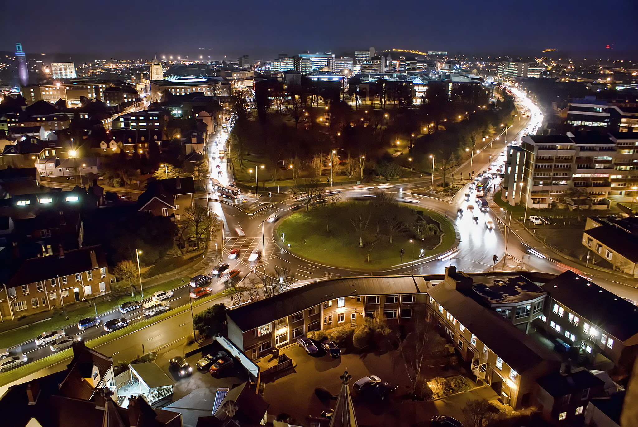Long exposure shot of traffic on a large roundabout at night