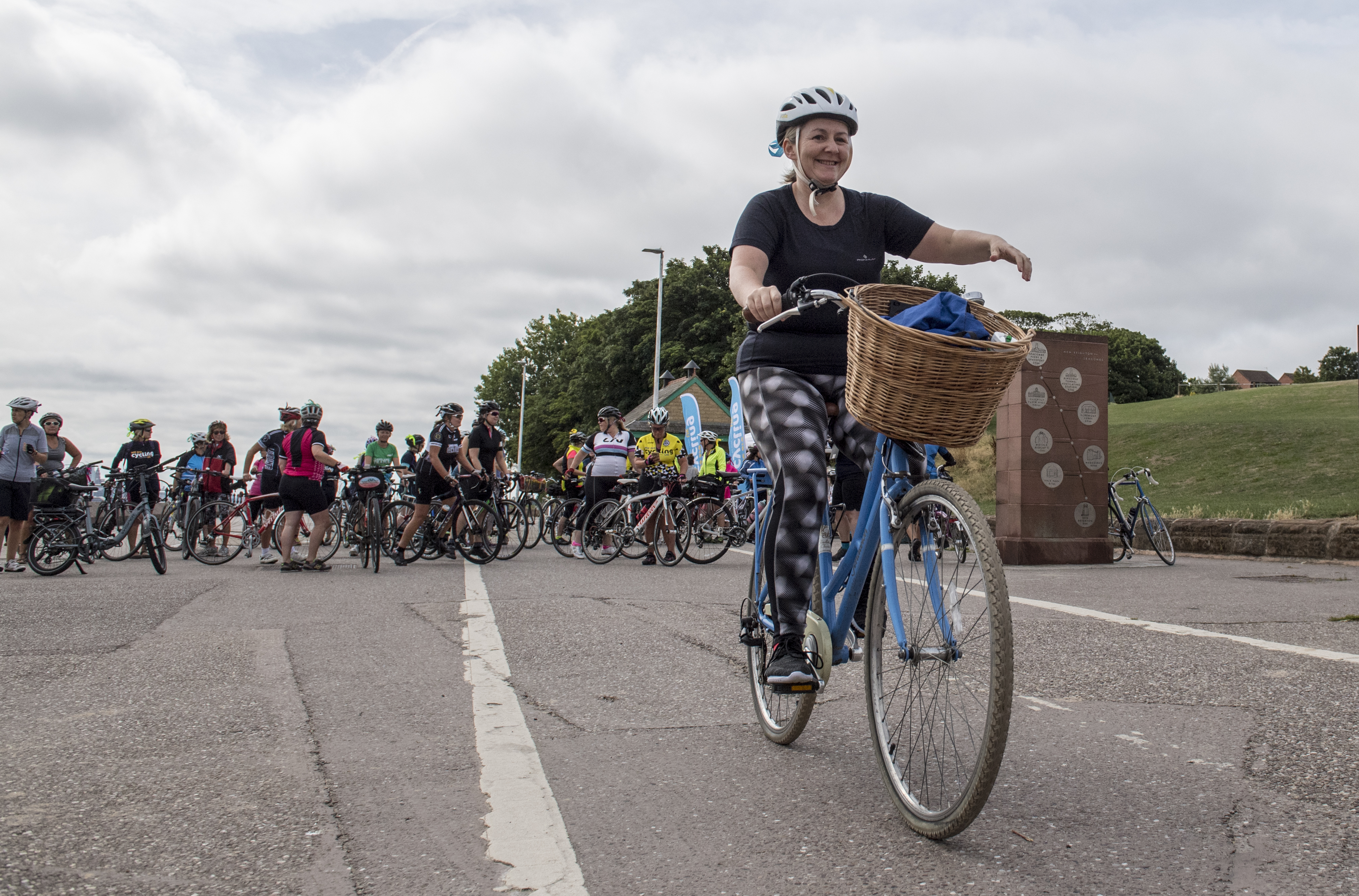 A woman on a blue bike with a basket