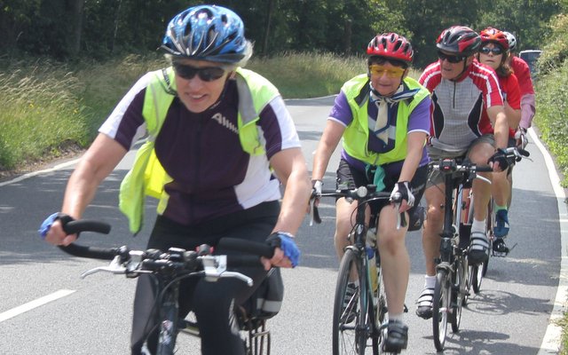 Female cyclist leading a small group
