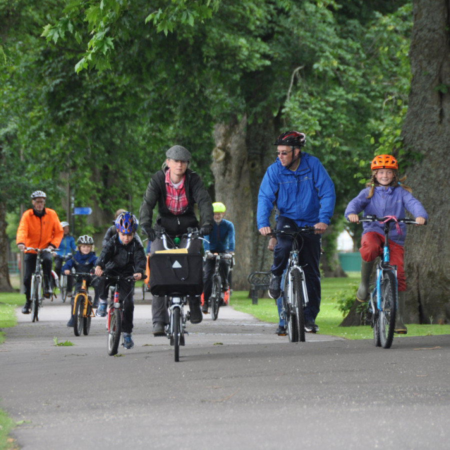Cyclists of many ages riding through Dock Park.