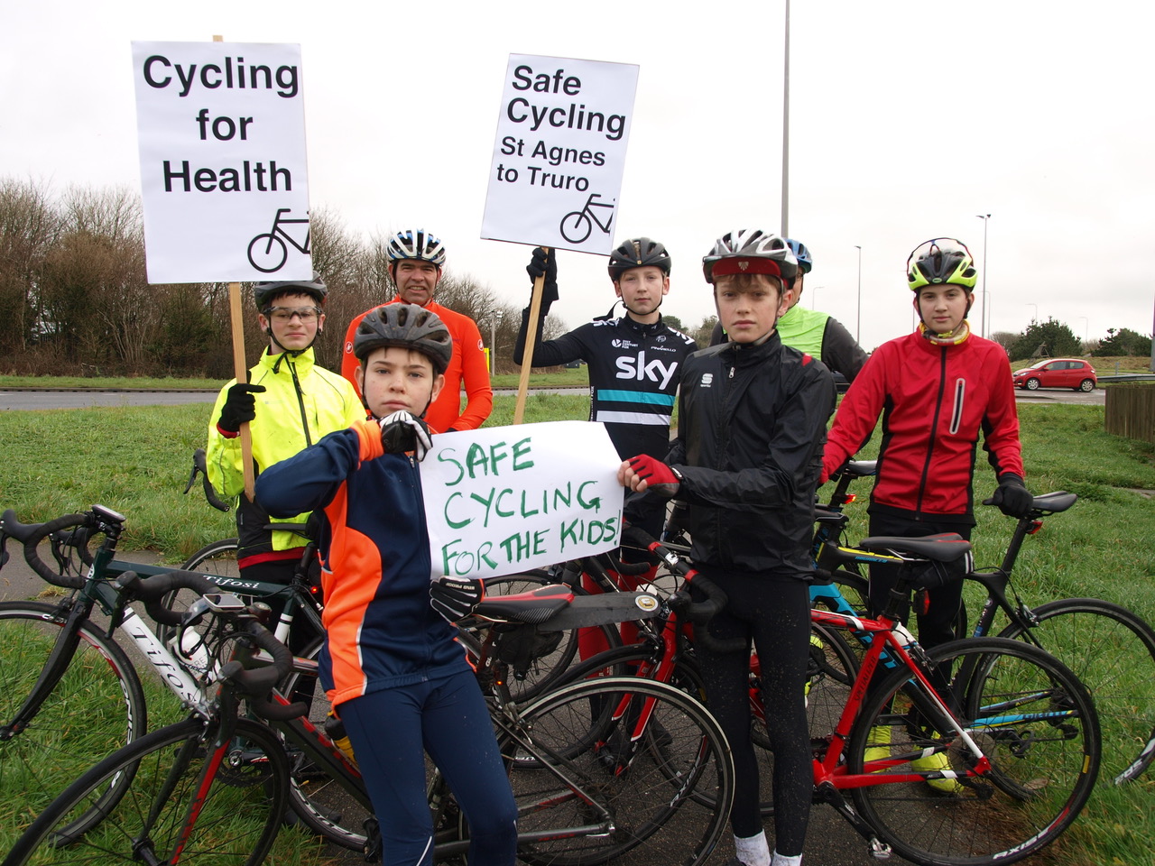 Group of young cyclists holding placards