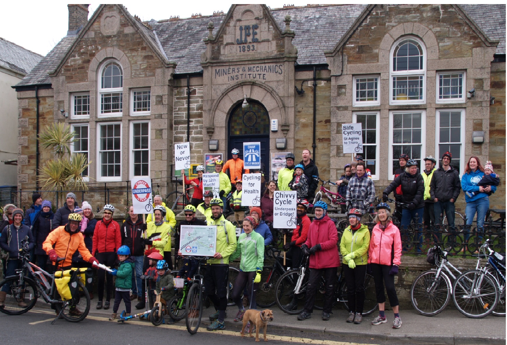 Group of cyclists holding placards