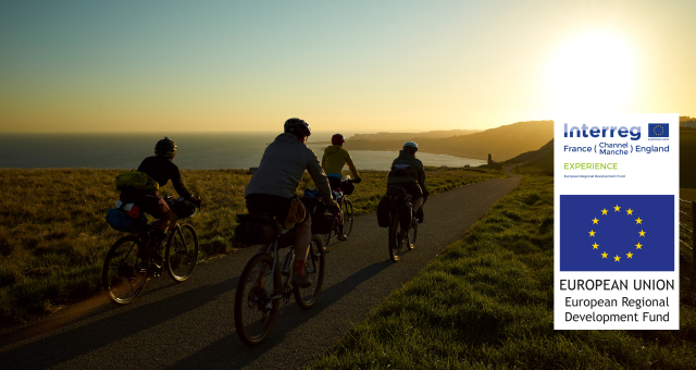 People cycling along the coast at sunset