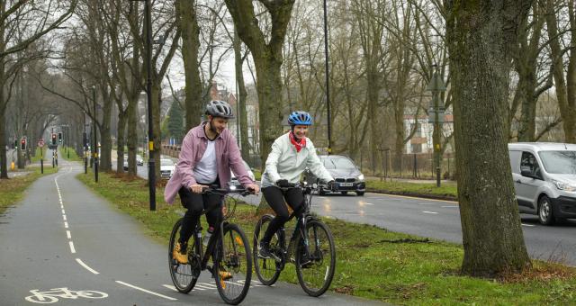 Two people cycling on a cycle lane (c) Joolze Dymond