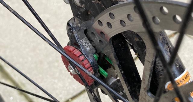 A close-up shot of the rear wheel of a mountain bike showing the disc brakes