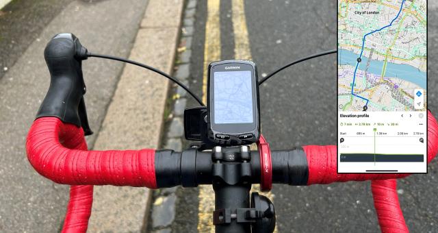 A close-up of a bike drop handlebar with a Garmin bike computer attached, showing a route. There's also an inset of the same route on a phone using Komoot