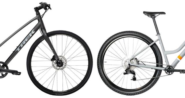 Two step-through hybrid bikes, a black one from Trek on the left, a grey one from Islabikes on the right