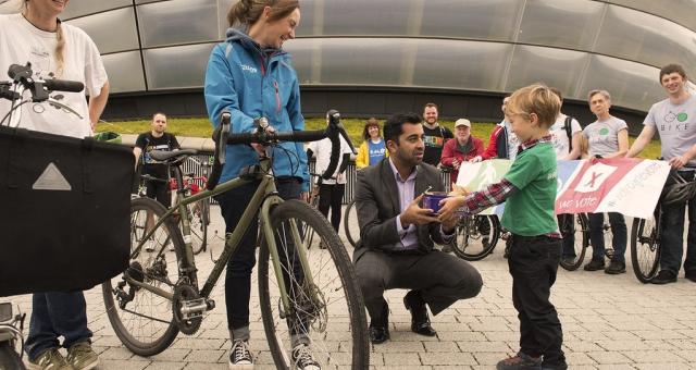 Cake being given to Scottish Transport minister