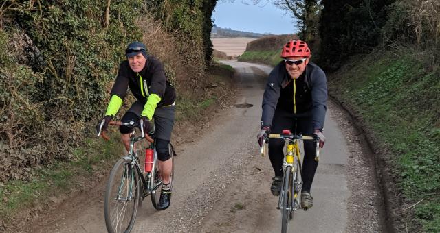 Two cyclists on a country lane