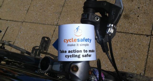 A Cycle safety: make it simple handlebar flyer attached to bicycle