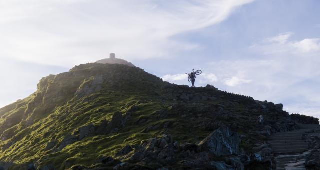 Lone cyclist heading up Mount Snowdon in the early morning