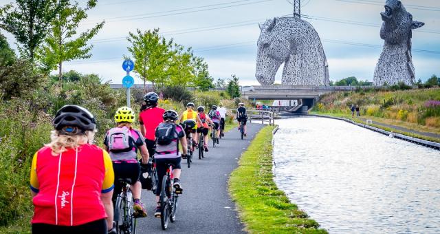 Participants riding past the Kelpies in Falkirk on the Belles Big Ride