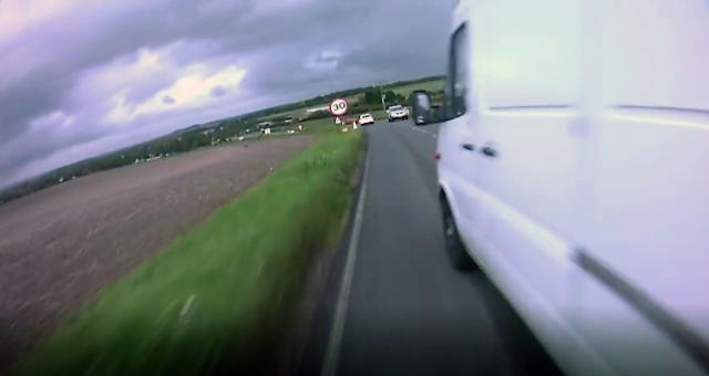 A van close passes a cyclist