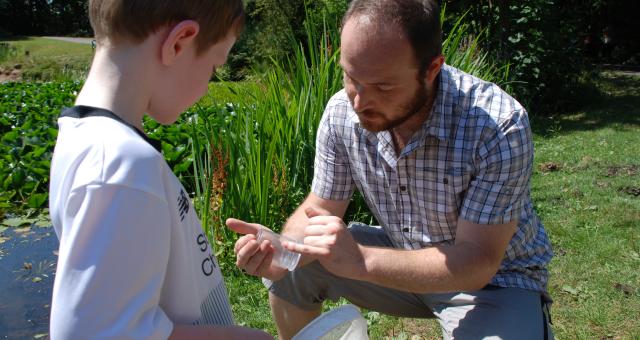 Wildlife expert Ben Deed telling Cillian McIlroy all about the local pond life