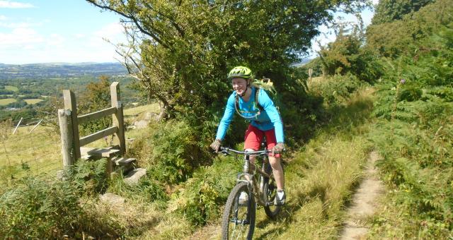 Woman cycling off-road in Wales