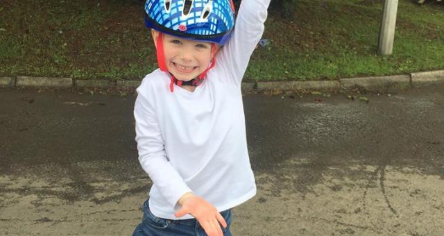 A child with bike smiling