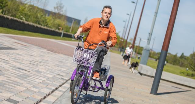 Ian Tallach rides an e-trike