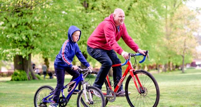 Father and son cycling together. Photo by Julie Skelton