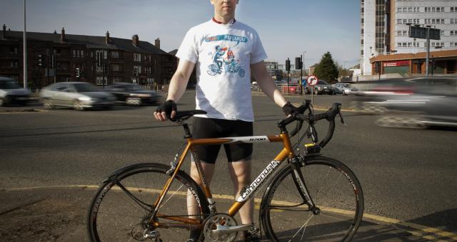 David Brennan standing with his bicycle