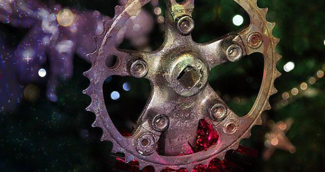 A recycled silver bike part hanging on a Christmas tree as a decoration