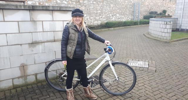 Woman standing with bike