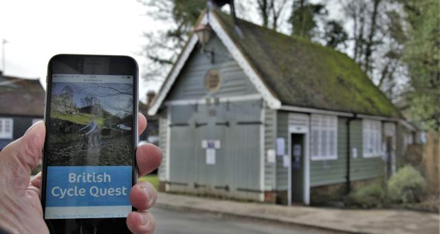 Man holding phone up showing Cycling UK website