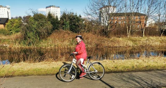 woman with bike on canal towpath