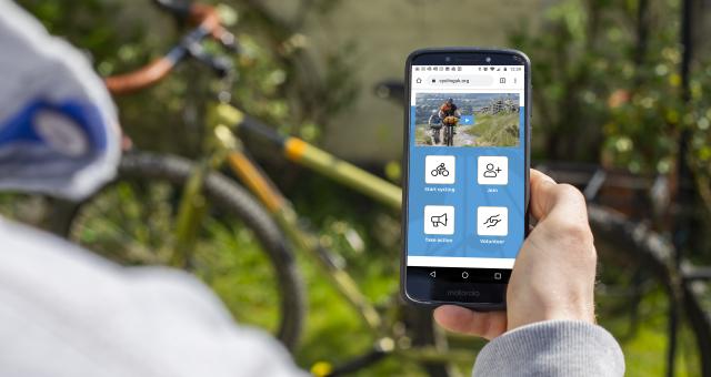 Anonymous person looking at Cycling UK website on smartphone
