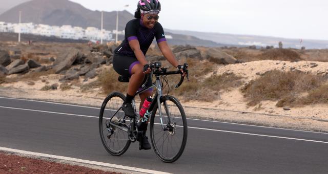 A woman cycles on a road bike