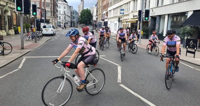group of cyclists riding in London street