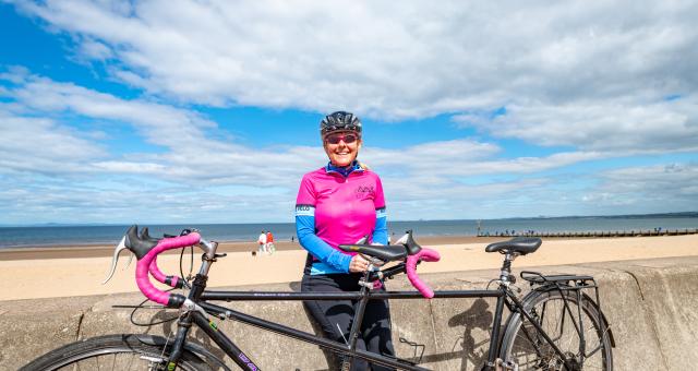 woman with tandem at seafront
