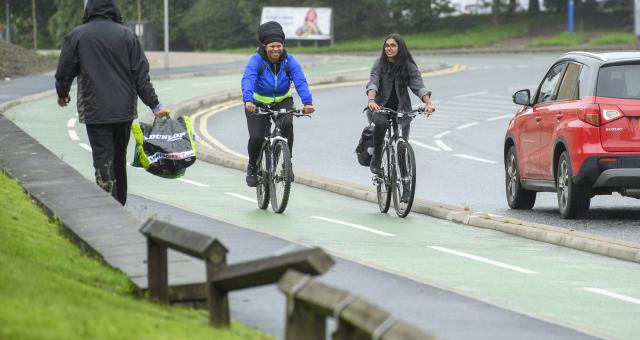 Two cyclists using segregated cycle lane in urban area