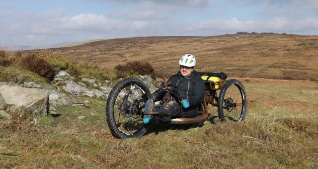 man on handcycle in off-road location in hills