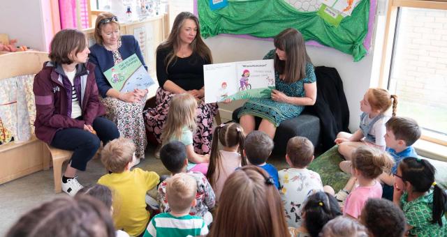 Scottish Minister for Children and Young People Clare Haughey reads a book about cycling to nursery children