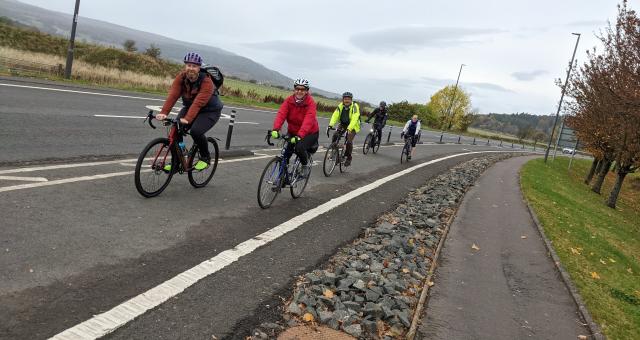 Five cyclists riding on a cycle path in Stirling