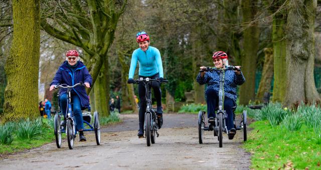 Dame Sarah Storey smiles as she pedals blue e-trike alongside participants through Debdale Park in Manchester on March 21 2023. Public event took place to mark the launch of Cycling UK's new e-cycle scheme, Making cycling e-asier, at Wheels for All.
