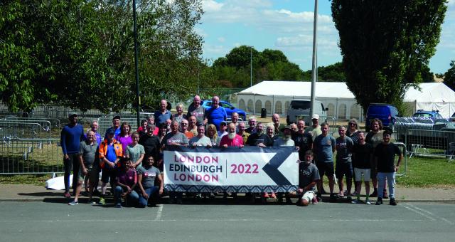 A large group of people stand behind a banner which reads London Edinburgh London 2022