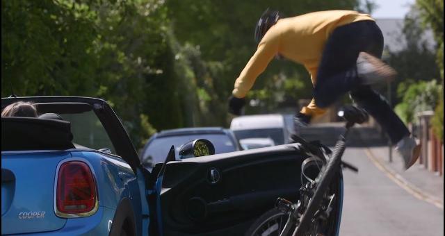 A cyclist being hit by a car door.