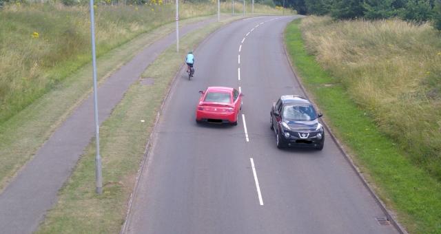 Cyclist on Gresley Way being overtaken by a car